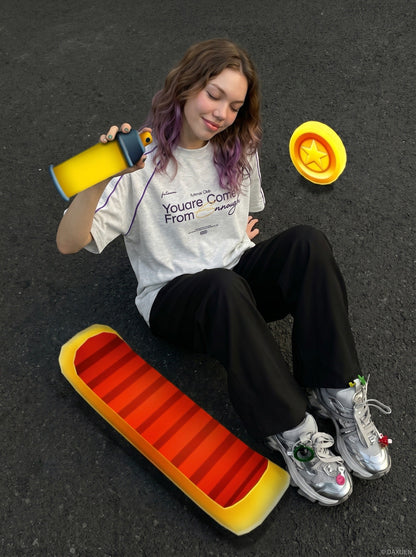 Model wearing oversized graphic T-shirt with raglan sleeves