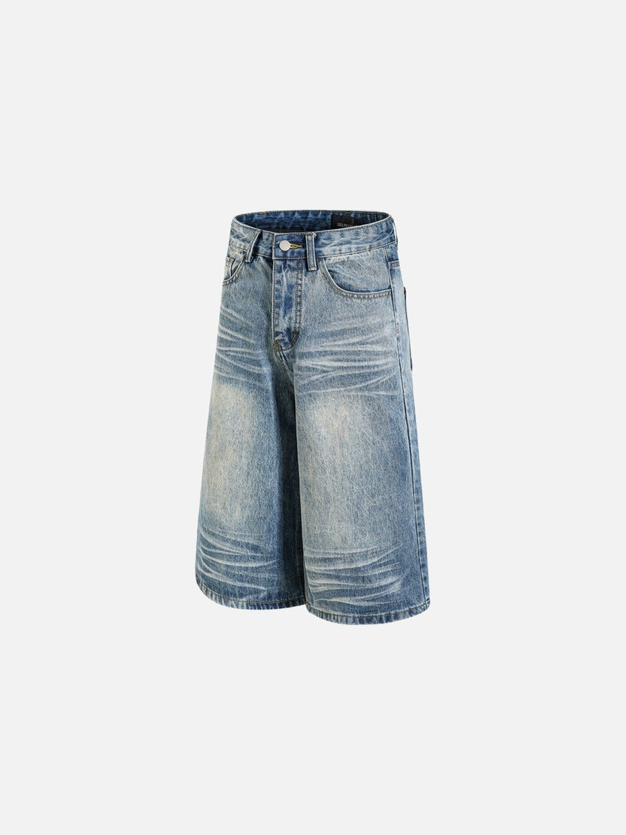 Close-up of hem and washed finish on faded black denim shorts