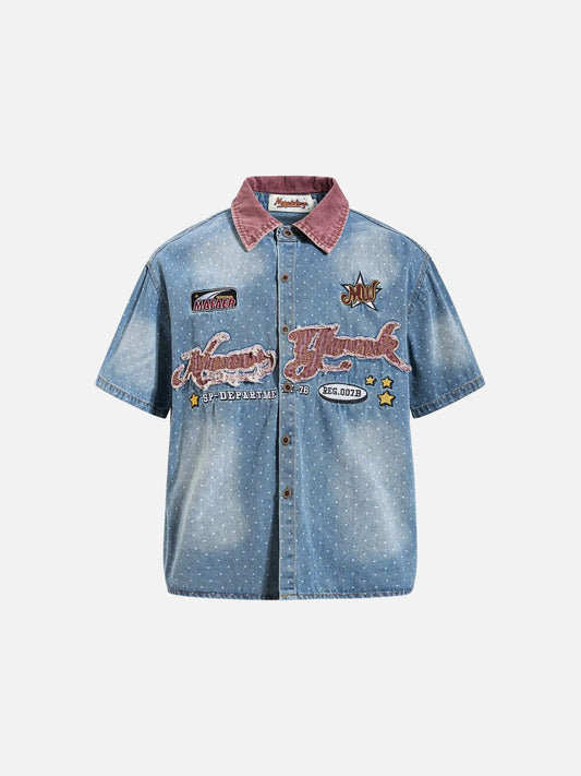 Front view of faded blue denim shirt with embroidered chest detail