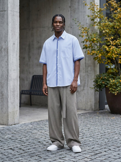Striped button-up shirt shown on model from the back