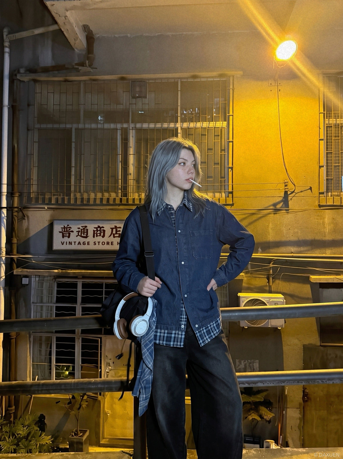 Back view of oversized layered denim shirt with blue plaid panels