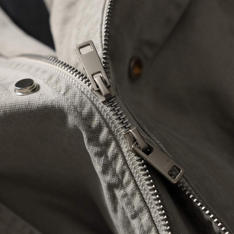 Model wearing light grey hooded bomber jacket in washed cotton