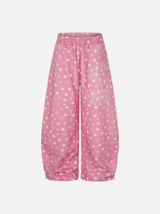 Front view of wide-leg star print trousers with drawstring waist