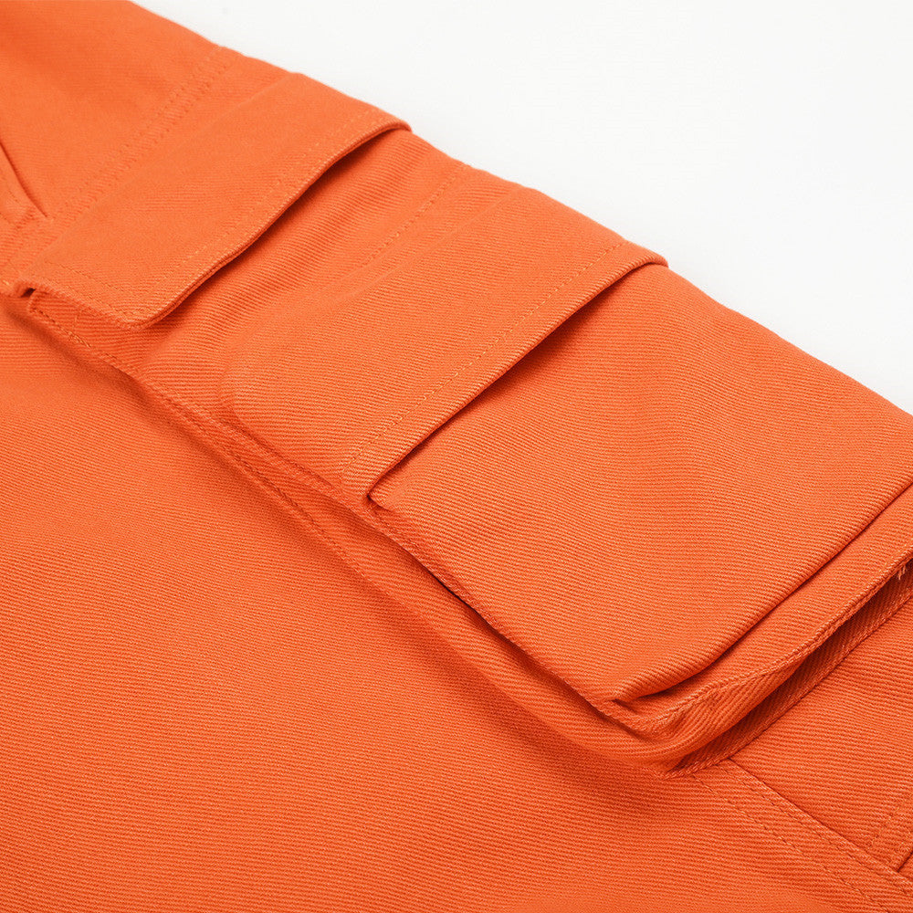 Vibrant orange trousers showing the wide-leg silhouette