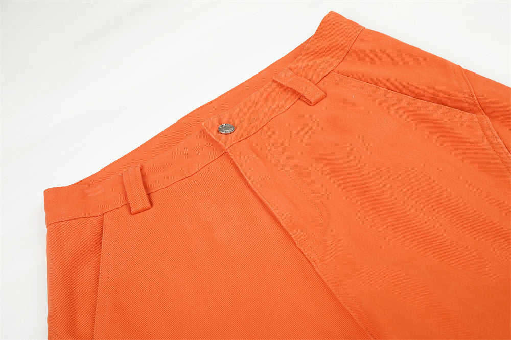 Orange cargo trousers displayed to show their relaxed wide-leg shape