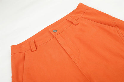 Orange cargo trousers displayed to show their relaxed wide-leg shape