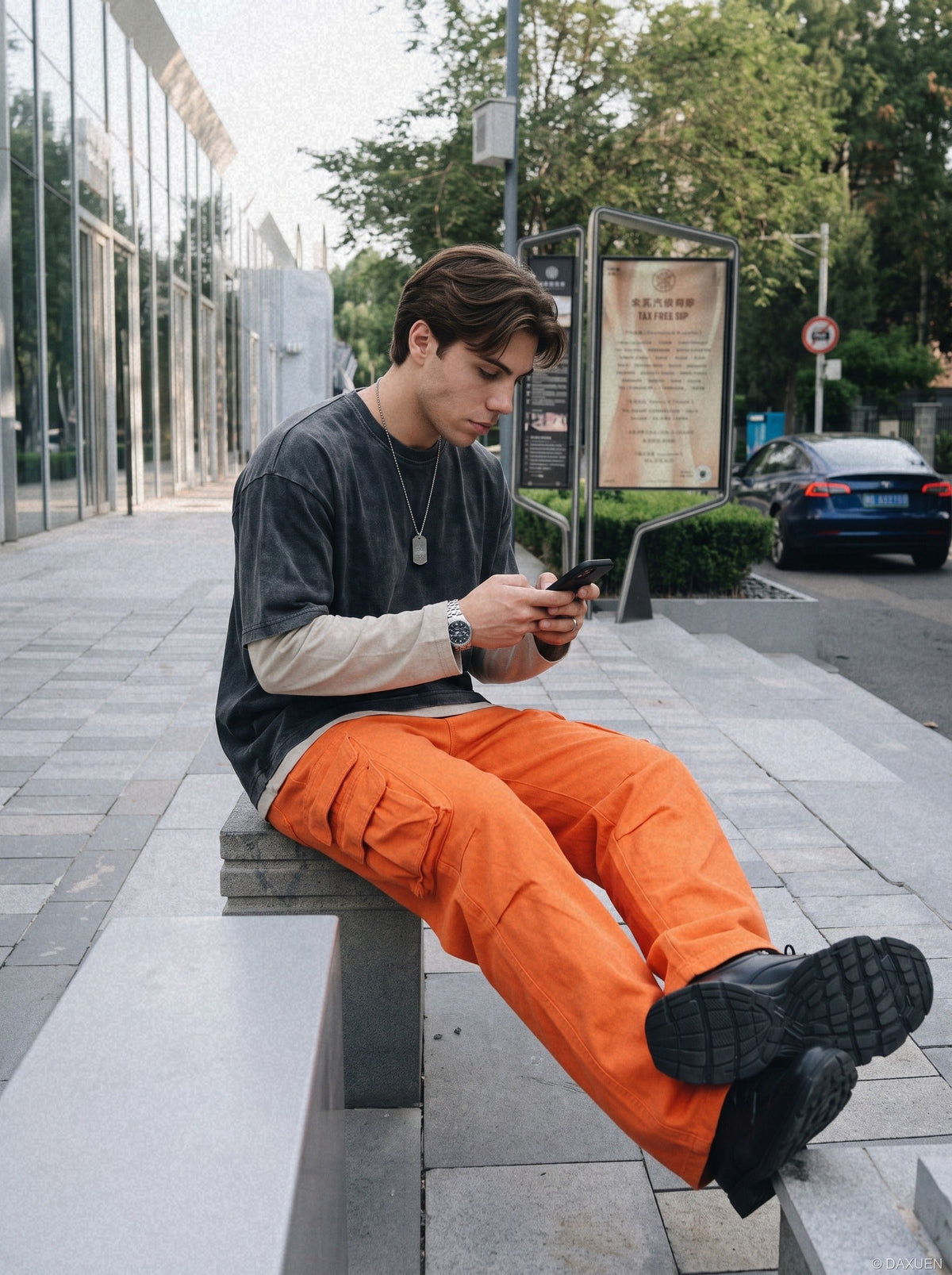 Side view of vibrant orange cargo trousers with a relaxed fit