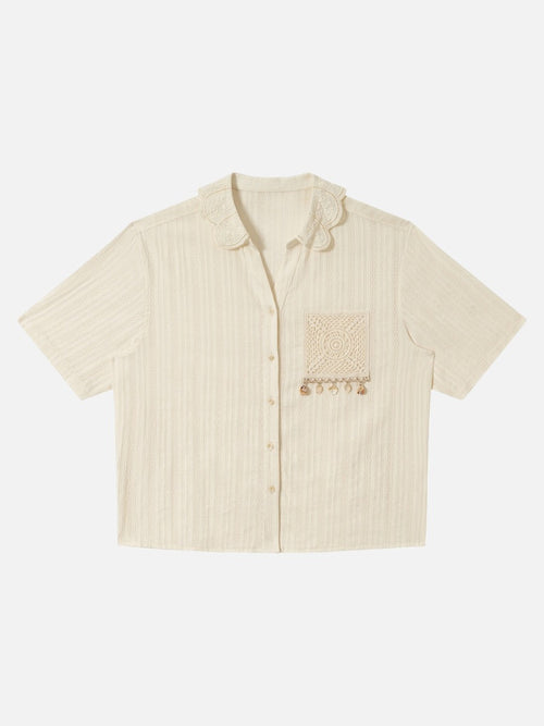 Front view of embroidered short sleeve shirt with shell detail