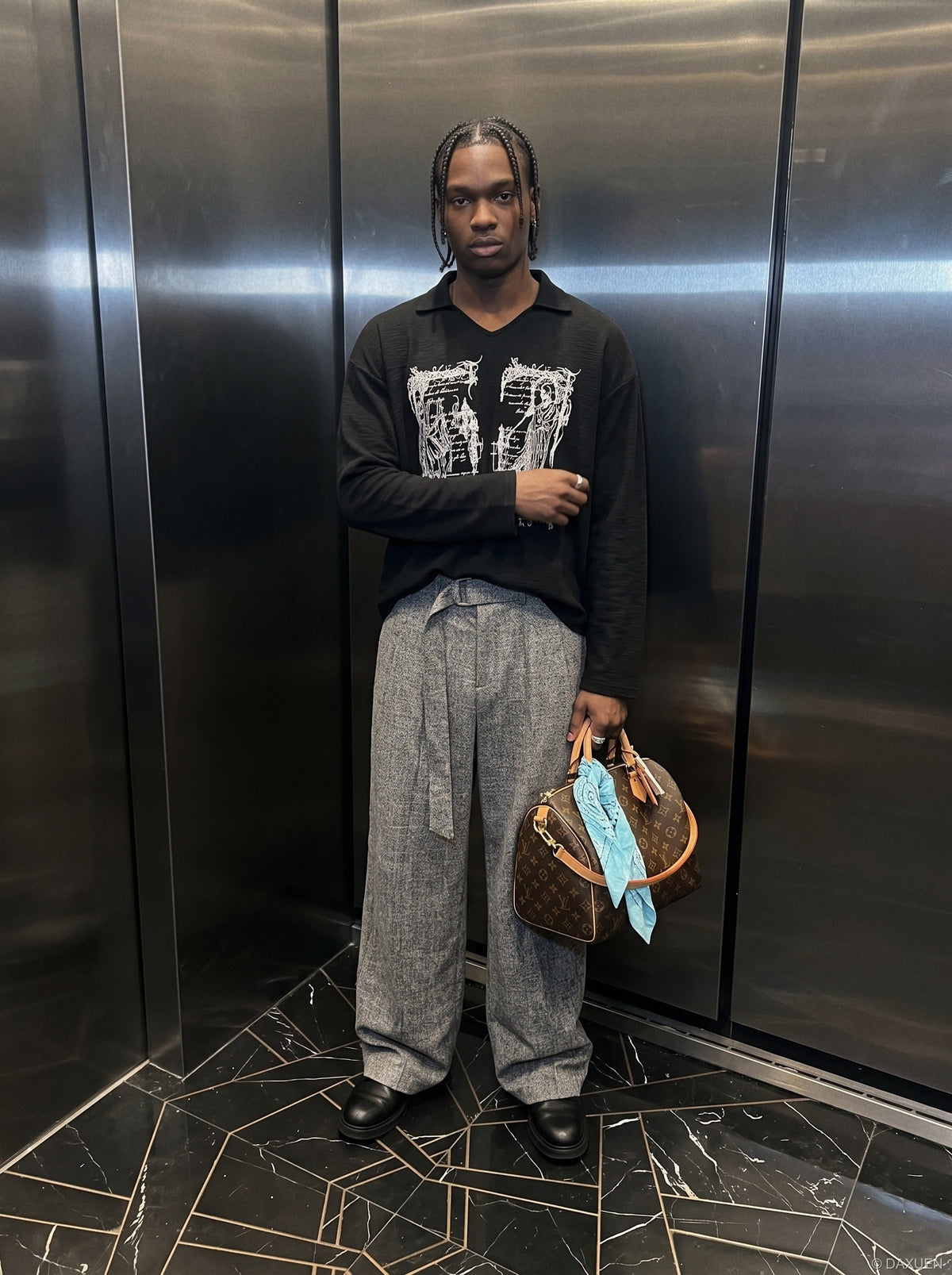 Oversized long sleeve graphic knit top styled on model from the front