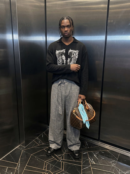 Oversized long sleeve graphic knit top styled on model from the front