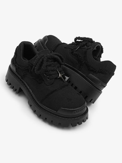 Black platform trainers shown together for a casual footwear look