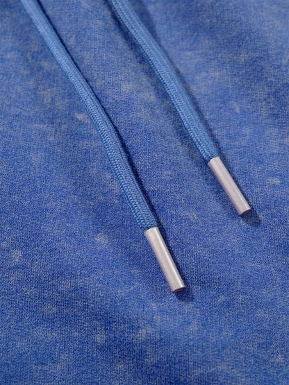 Detail of drawstring waistband on washed sweat shorts