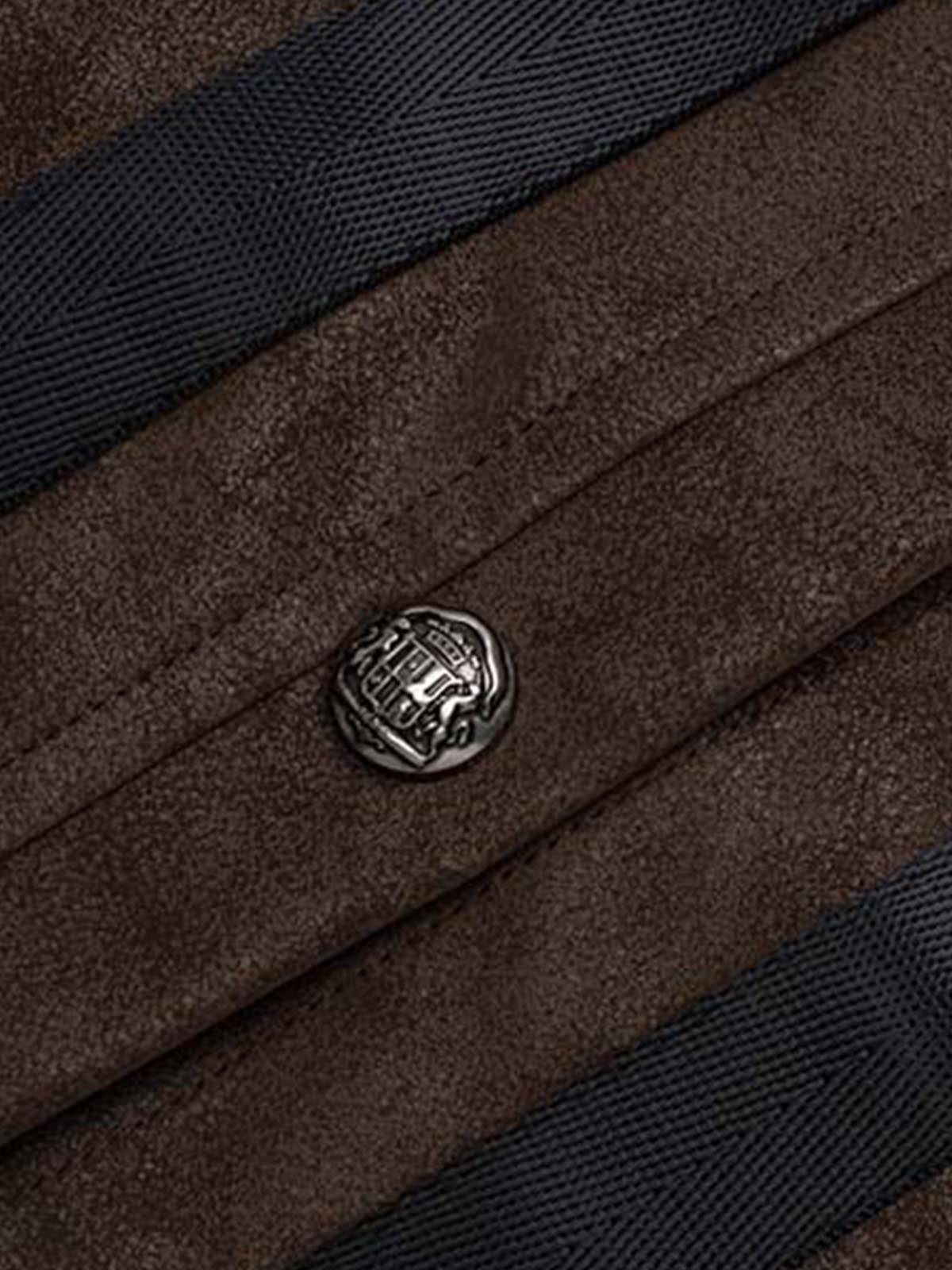 Detail of the jacket collar and layered brown faux leather patchwork panels
