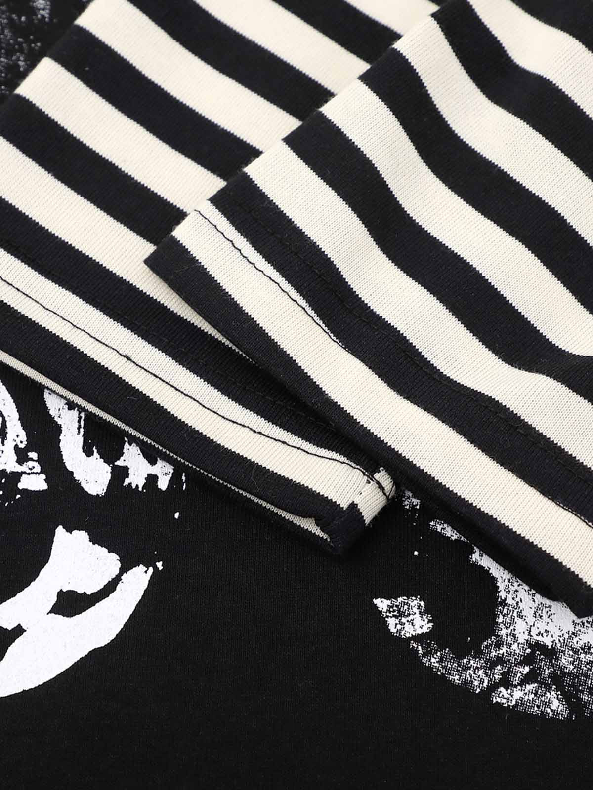 Fabric close-up of dark striped oversized long sleeve graphic T-shirt
