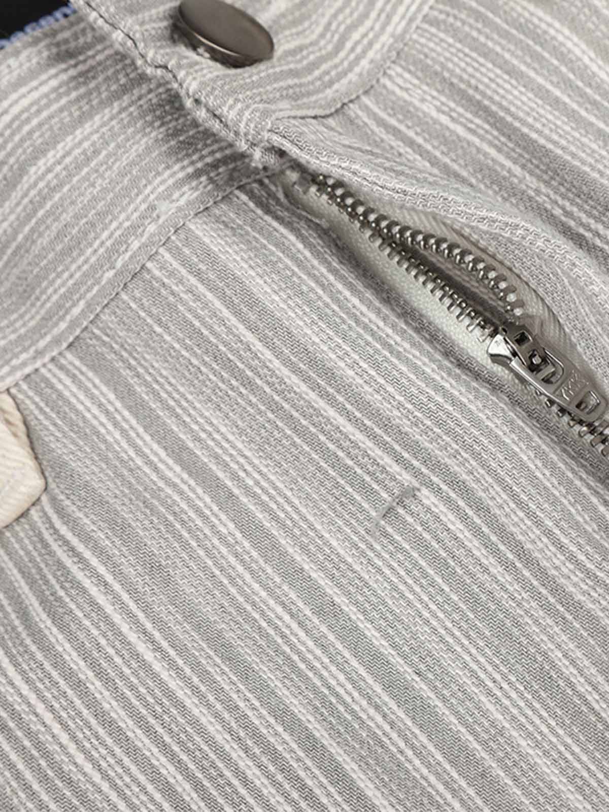 Side view of graphic print jeans with a chain-trimmed pocket