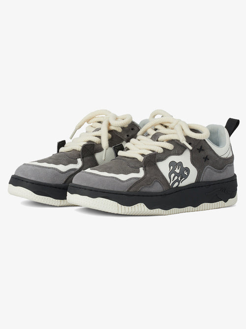 Camouflage street trainers with reflective laces shown from the side