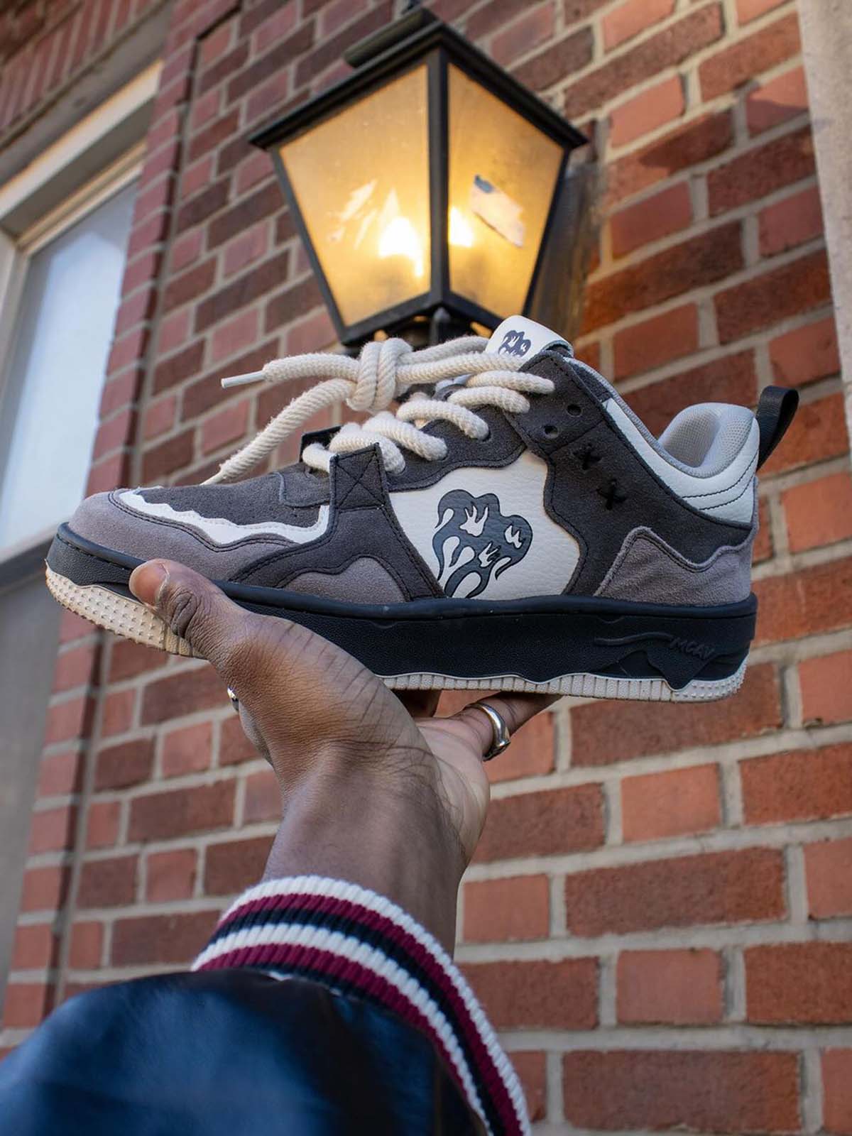 Camouflage trainers displayed together with reflective laces visible