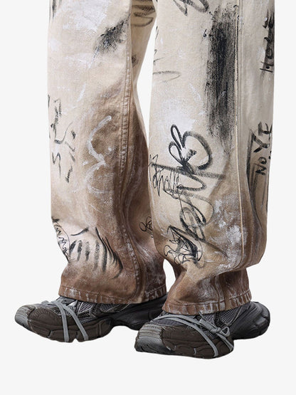 Close-up of distressed detailing on graffiti denim jeans