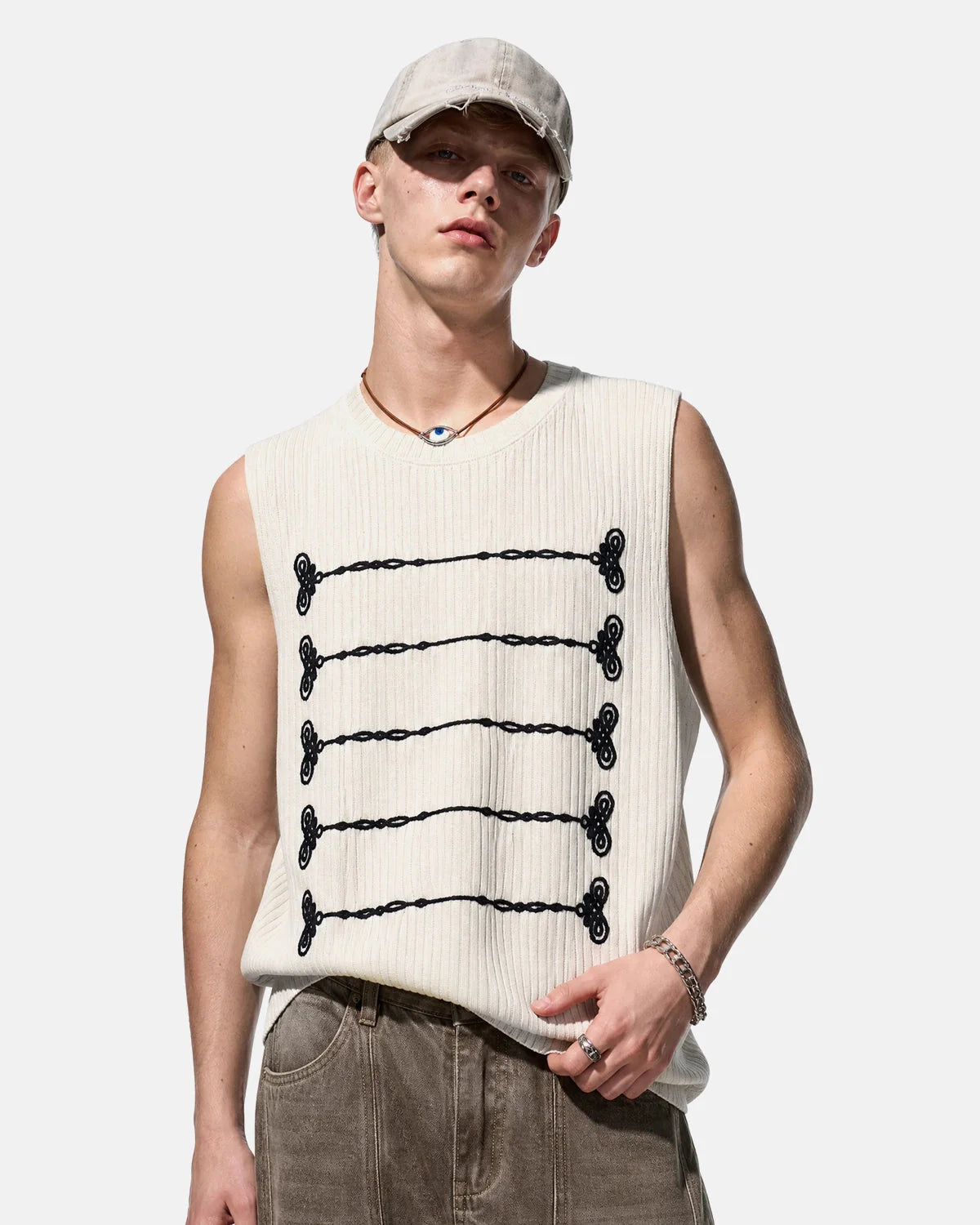 Full-length view of embroidered knit tank top styled casually