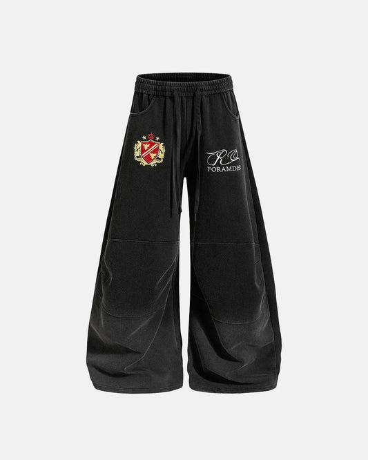 Front view of gothic washed barrel-leg sweatpants with graphic detail