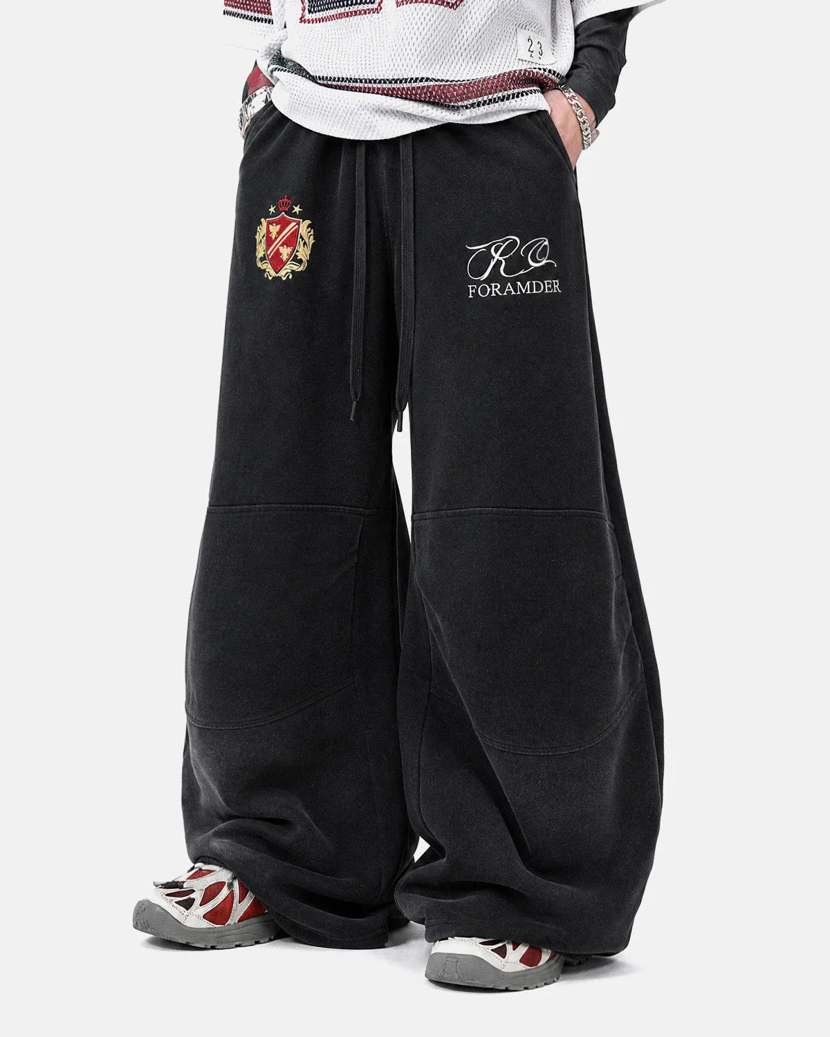 Side view of gothic graphic sweatpants with a relaxed barrel-leg fit