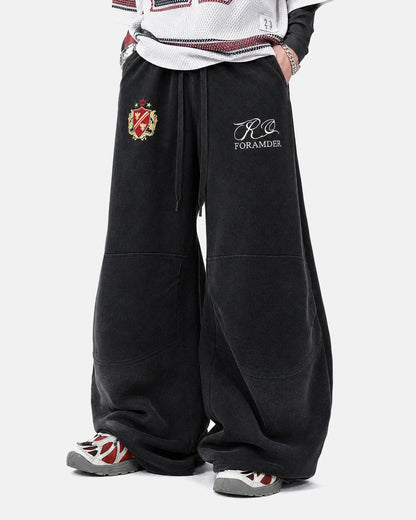 Side view of gothic graphic sweatpants with a relaxed barrel-leg fit