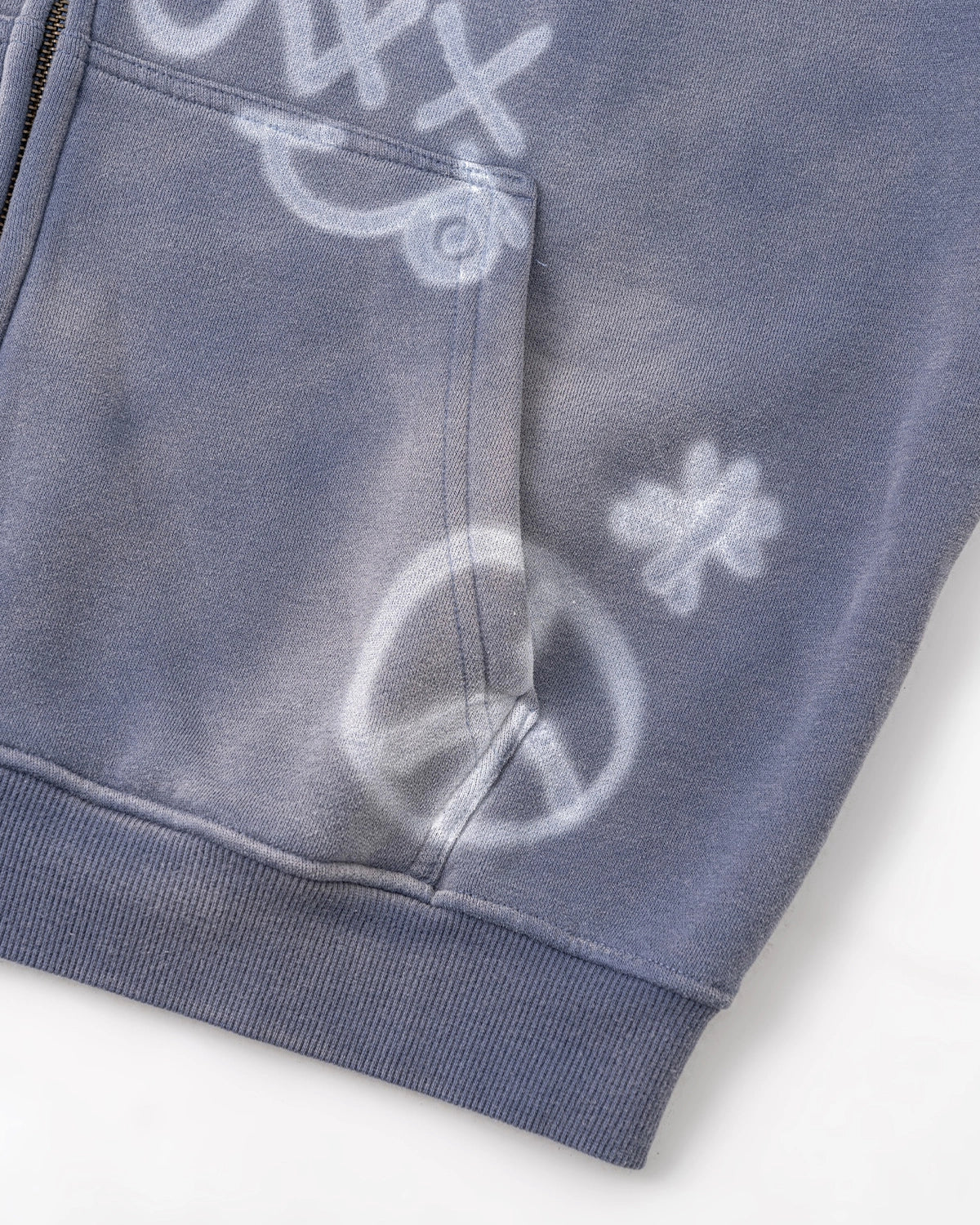 Casual styling of a washed graffiti zip-up hoodie