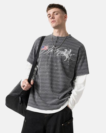 Model wearing layered stripe Henley T-shirt with jeans for streetwear