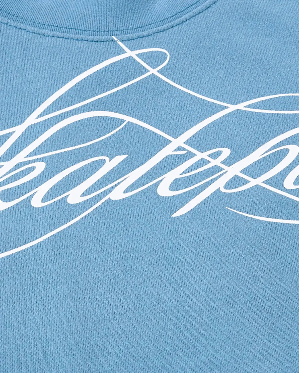 Detail view of fabric and Monkey Wash script print on baby T-shirt