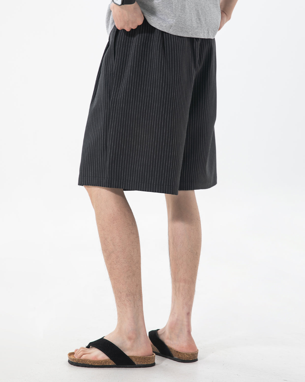 Close-up of pleated detailing on men's tailored shorts