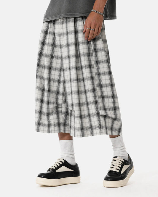 Front view of plaid longline casual shorts on a plain background