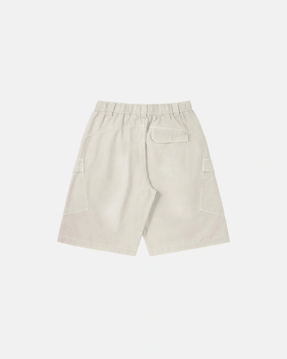 Waistband and button fastening detail on washed cargo shorts