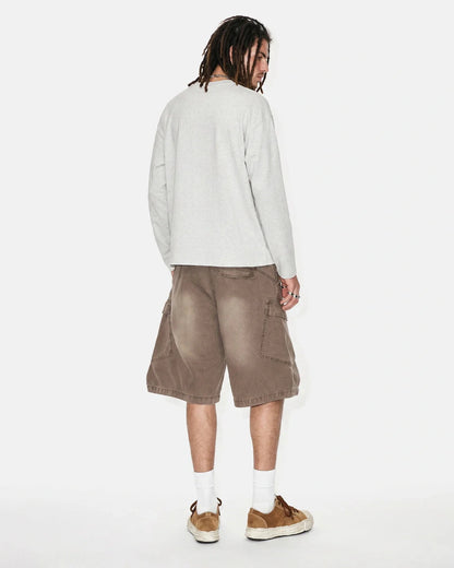 Close-up of utility pocket detail on washed cargo shorts